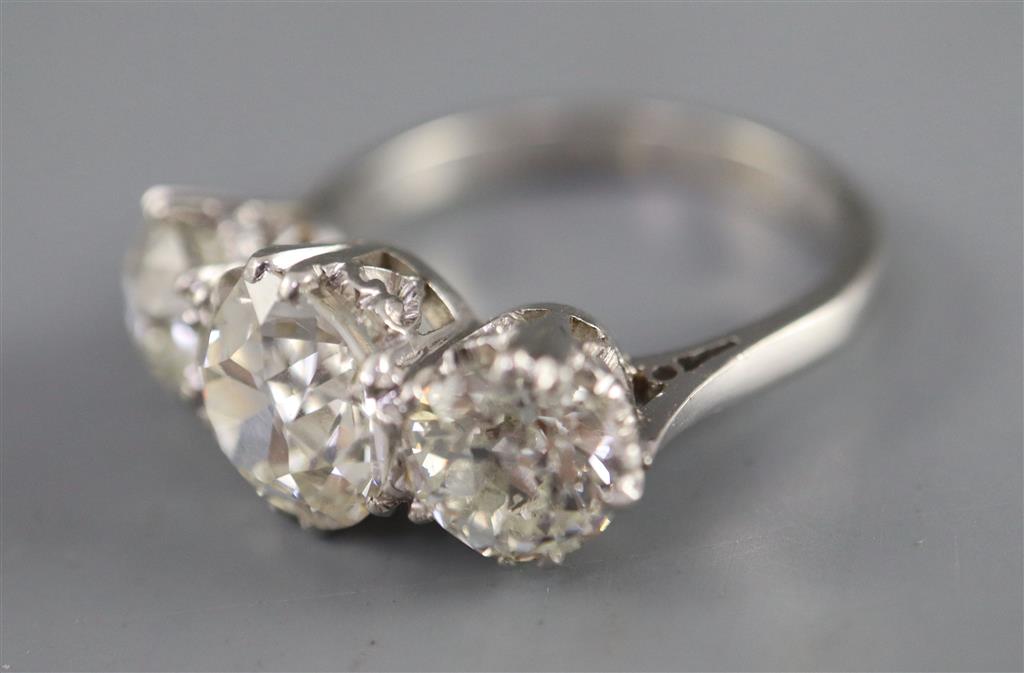 An impressive platinum and three stone diamond ring,